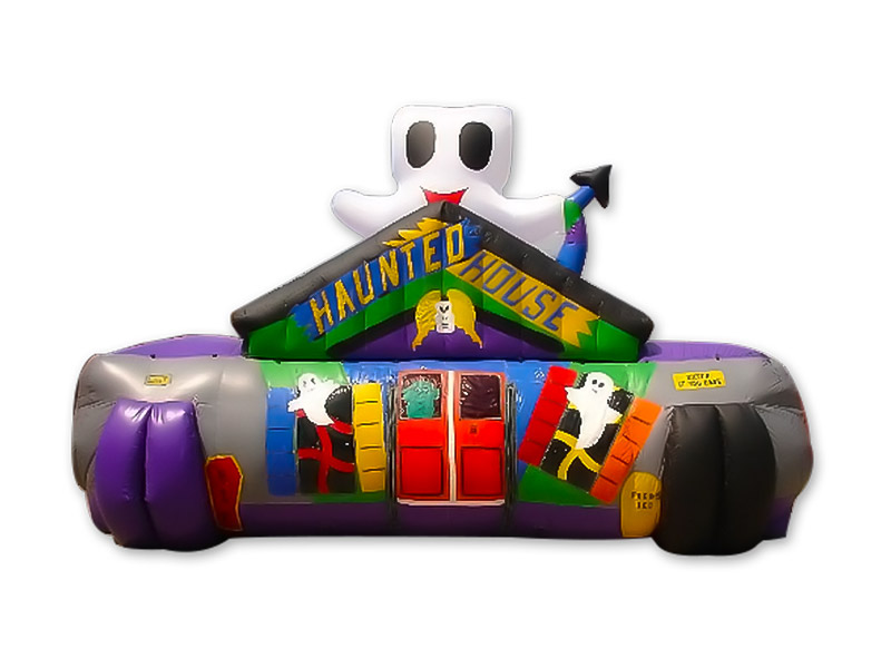 An inflatable haunted house. It is decorated with ghosts, a door, and the words Haunted House