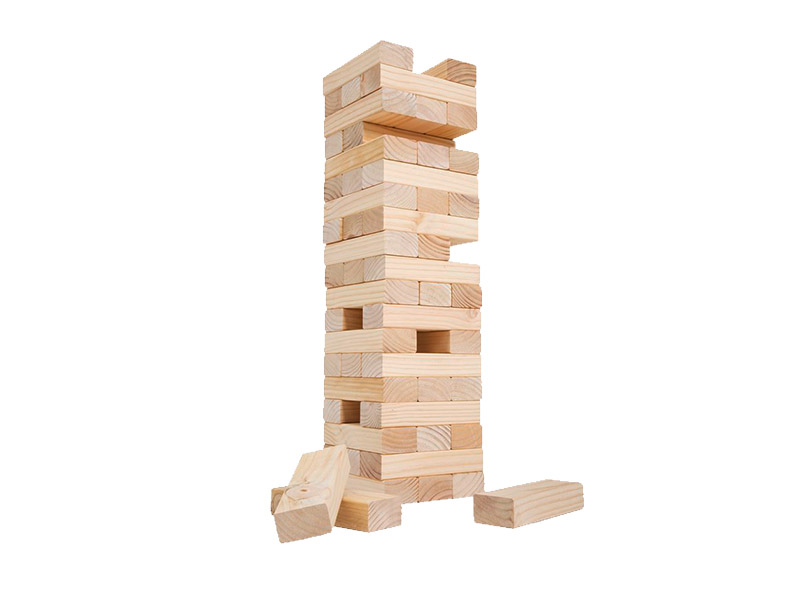 A game of Jenga, with a tall tower of wooden blocks precariously stacked on top of each other. Some blocks have been removed from the tower, leaving gaps