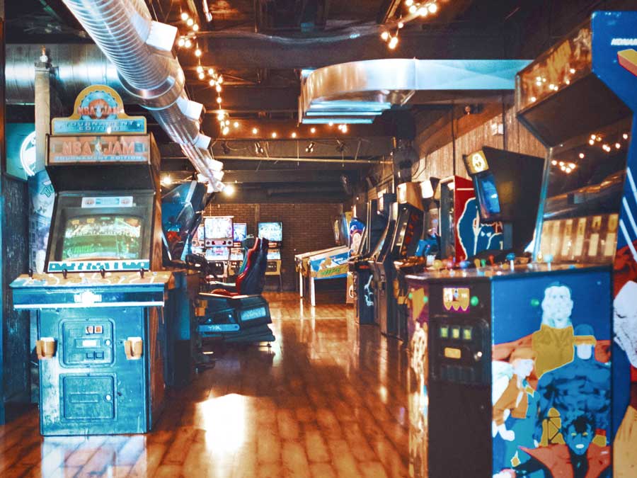 Vintage arcade room with classic arcade games set up.