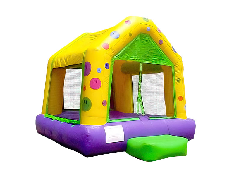 Colorful smiley face kids inflatable bounce house rental on a white background.