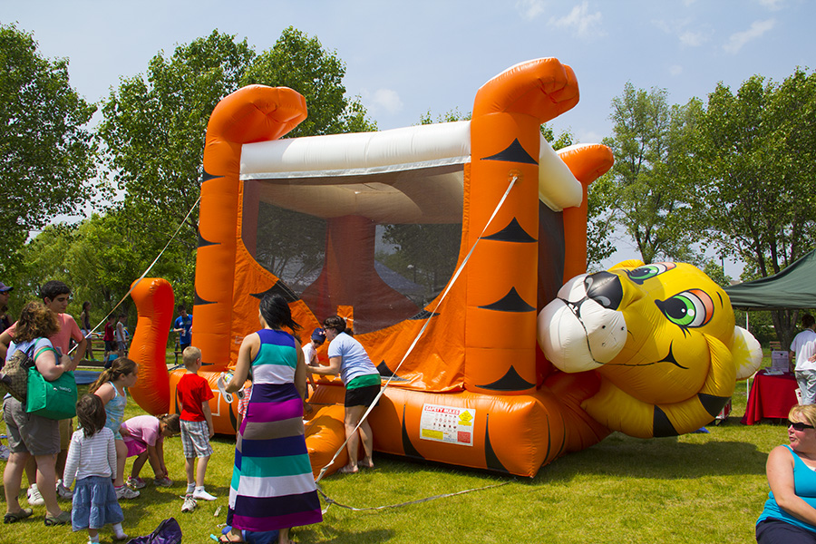 Children line up to enter a tiger themed Naperville bounce house rental.