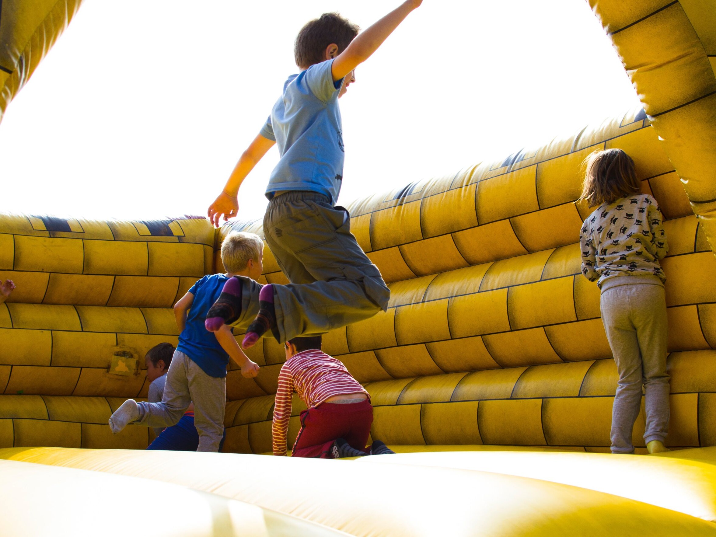 Kids jumping and having fun in an inflatable attraction.